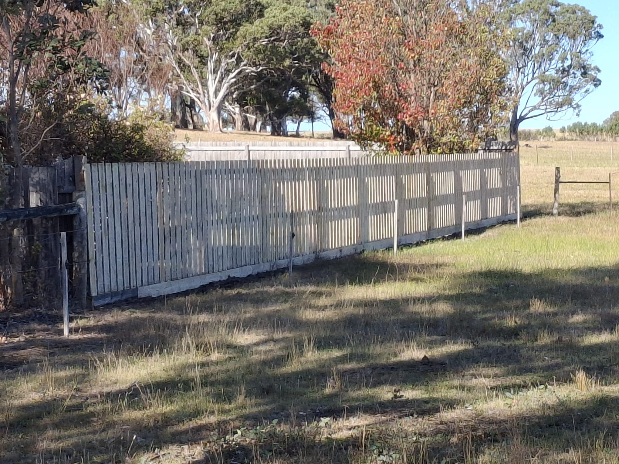 Gray vertical slat fence installation