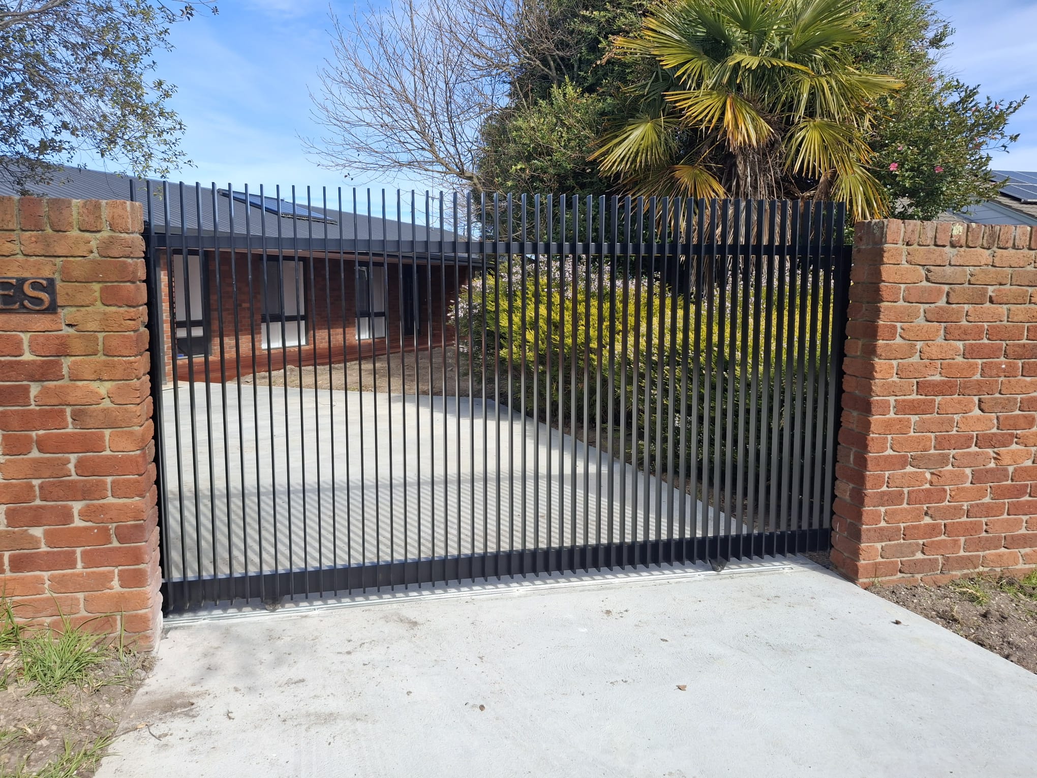 Security gate with brick pillars