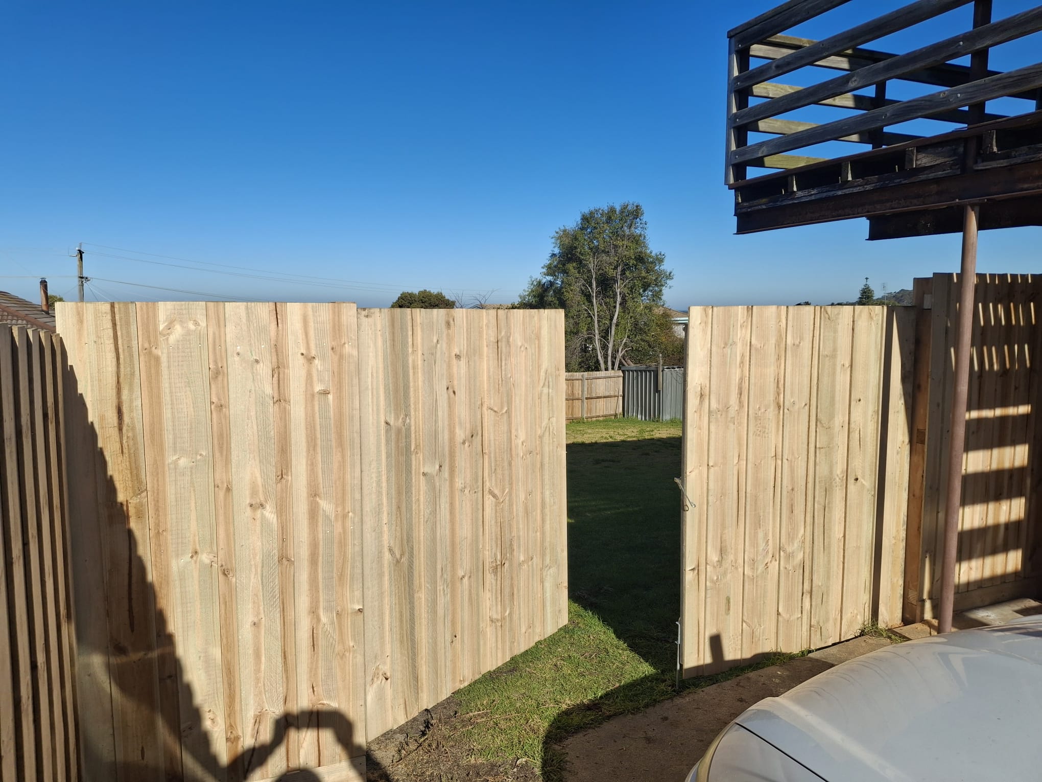 Timber fence with vertical slats
