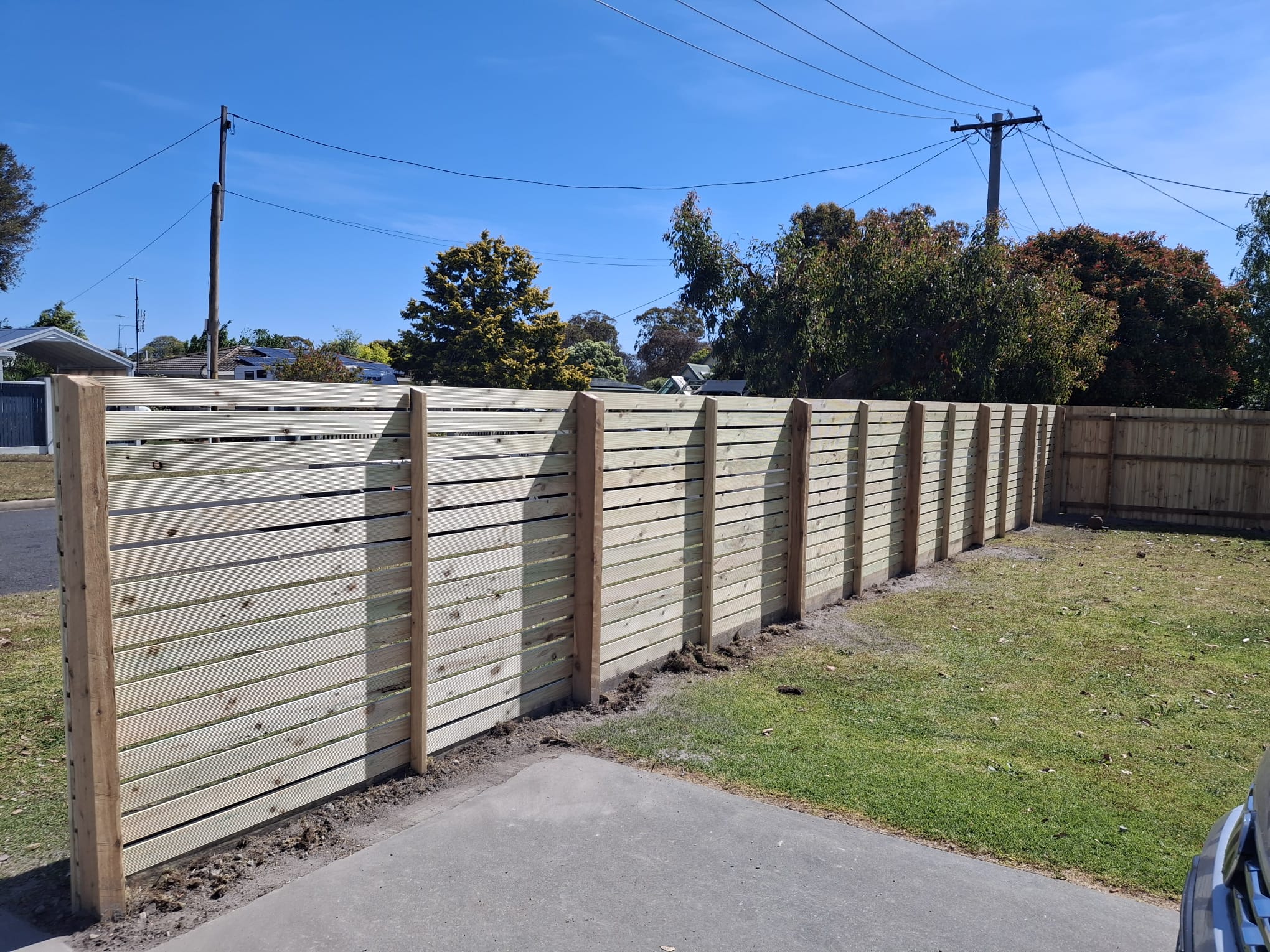 Horizontal slat timber fence